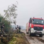 Firefighters battle wildfires in Belgium and Greece as 2 die on an island near Athens