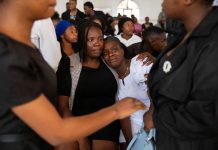 Mourners file into a church in Haiti where gangs killed dozens of people in latest rampage
