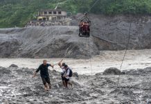 Nepal flood survivors cling to zipline to cross treacherous river